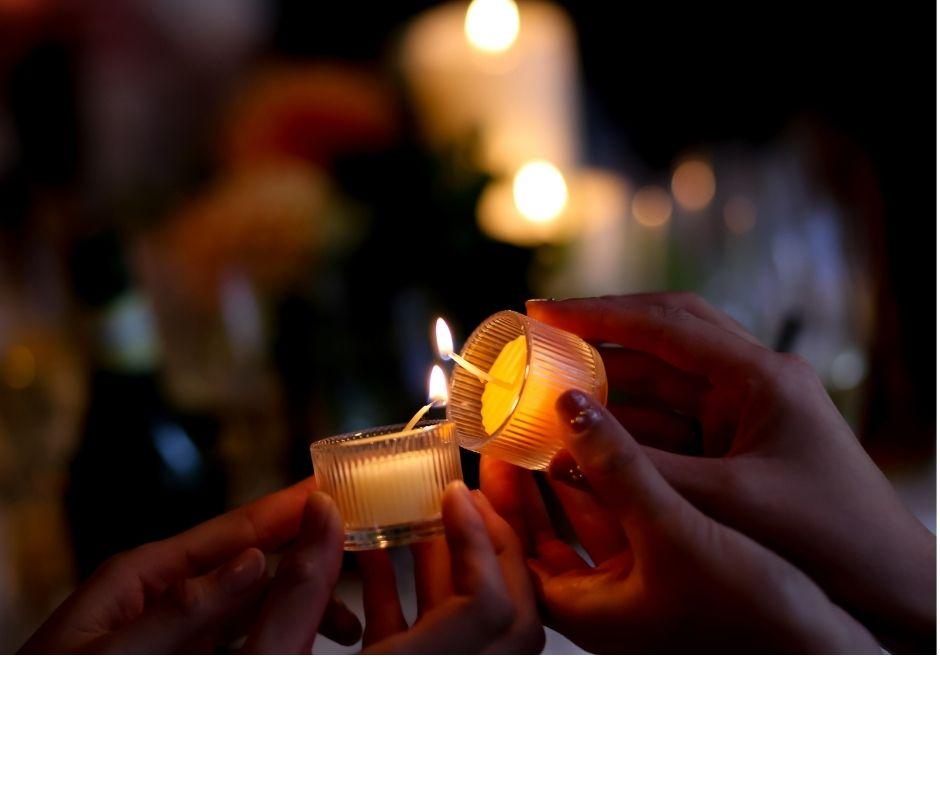two people lighting candle