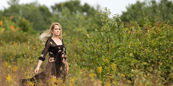 Erin in a field with herbs