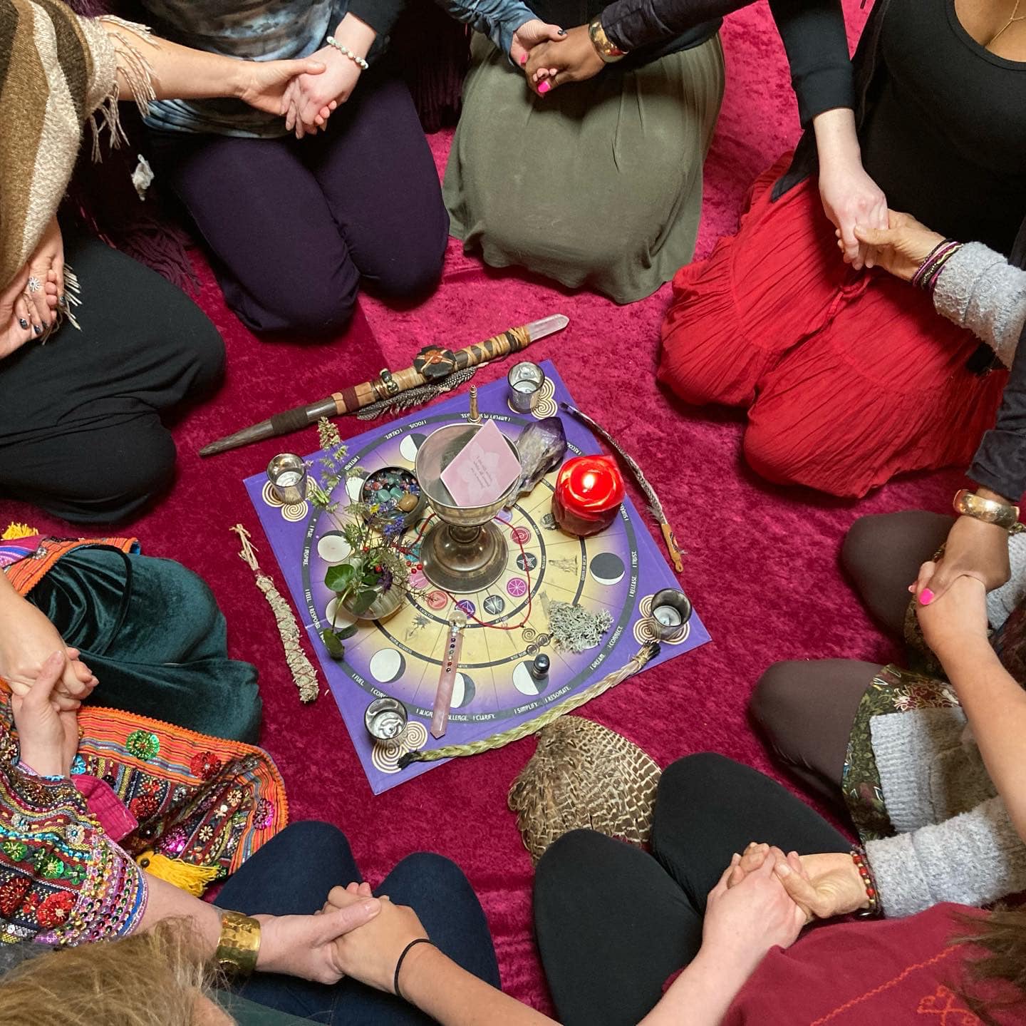 women in a circle holding hands