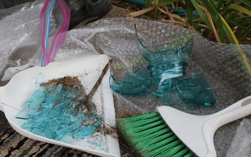 broken blue jar and dust pan